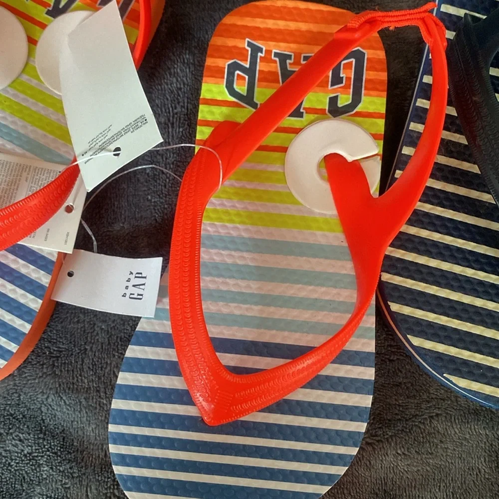 2 pairs Gap flip flops sz 10. NWOT blue/white striped. NWT neon orange striped.